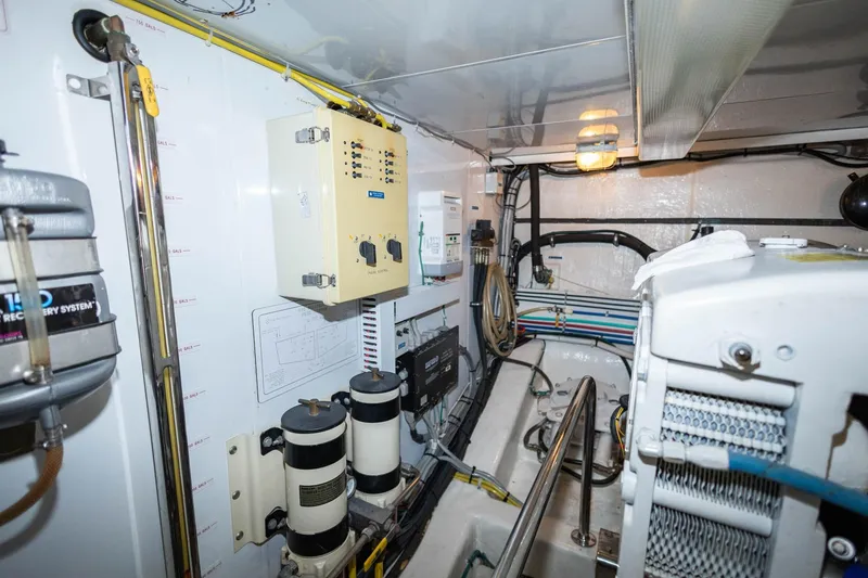 Slide: The Image of Engine room of 2005 Ocean Alexander Raised Pilothouse Flybridge Sedan, showcasing equipment and wiring. - 43