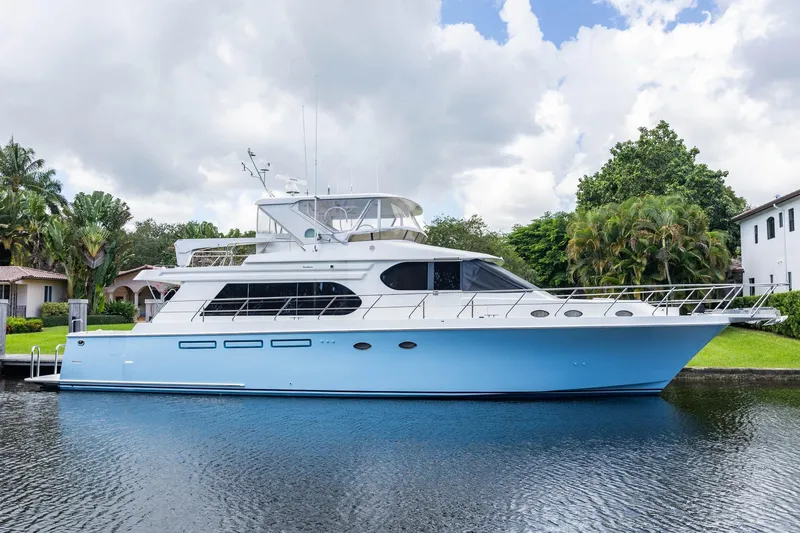 Slide: The Image of 2005 Ocean Alexander Raised Pilothouse Flybridge Sedan yacht docked by lush greenery. - 47
