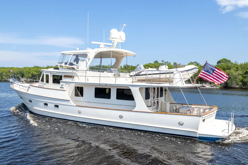 The Image of 2017 Fleming 65 yacht cruising on a sunny day with American flag. - 0