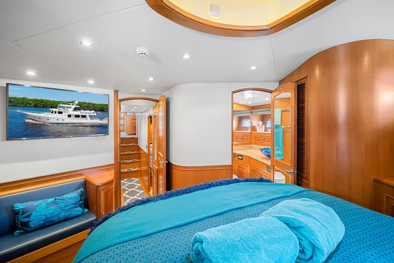 Slide: The Image of Luxurious 2017 Fleming 65 yacht interior with elegant wood finishes and plush bedding. - 10