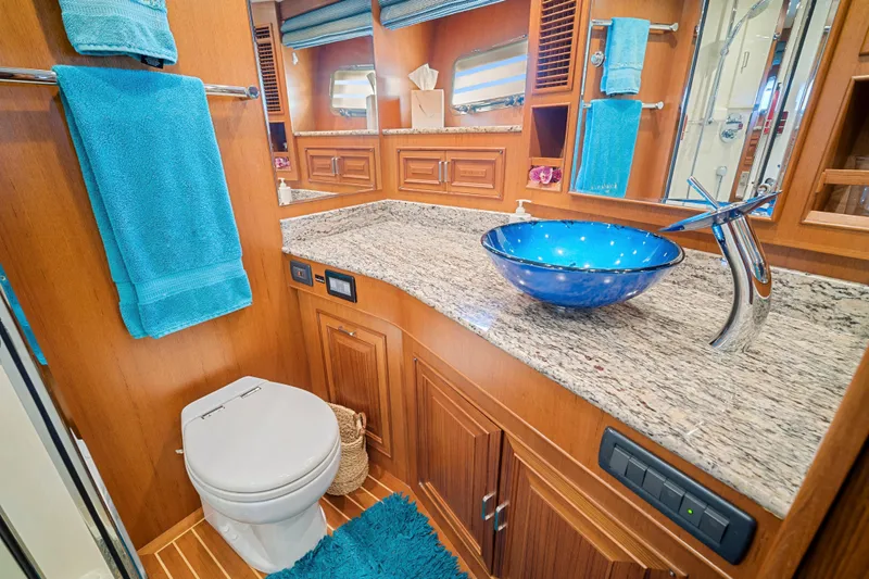 Slide: The Image of Luxurious bathroom in 2017 Fleming 65 yacht with blue glass sink and granite countertop. - 12