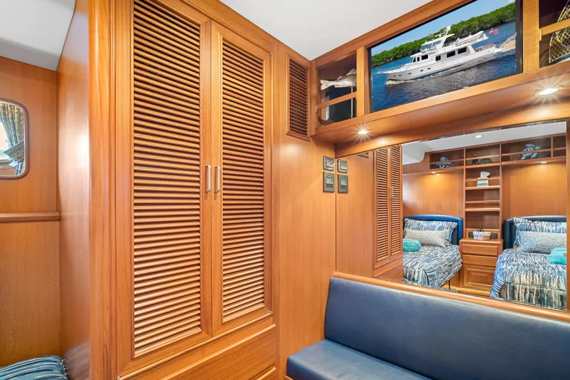 Slide: The Image of Luxurious 2017 Fleming 65 yacht interior with wooden cabinetry and twin beds. - 15