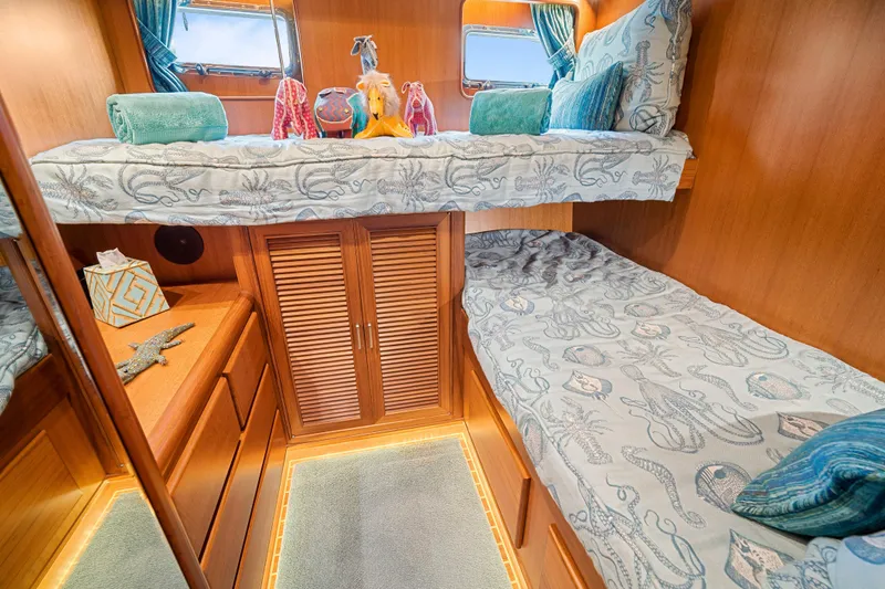 Slide: The Image of Cozy cabin interior of 2017 Fleming 65 yacht with bunk beds and nautical decor. - 16