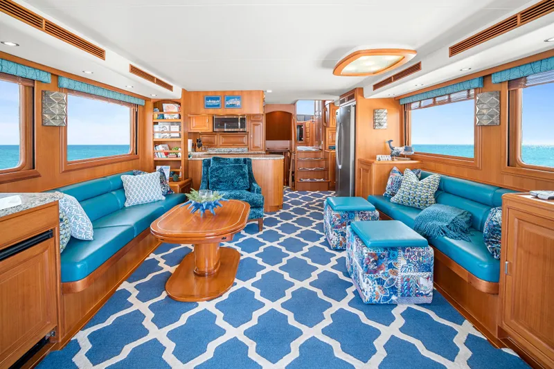 Slide: The Image of Luxurious 2017 Fleming 65 yacht interior with elegant blue and wood design, ocean view windows. - 2