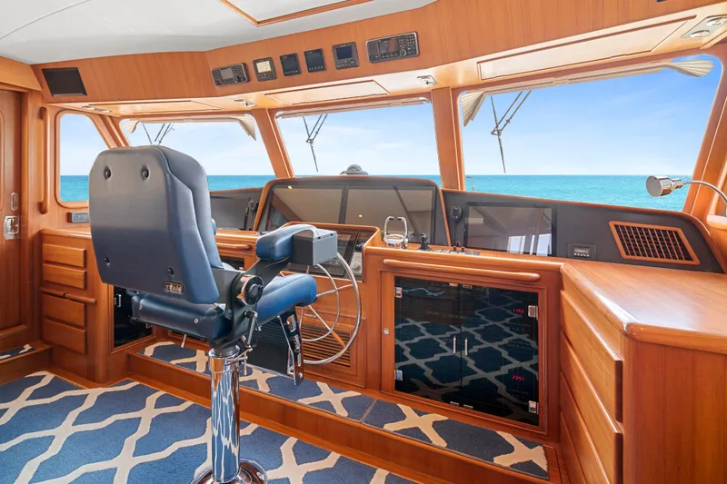 Slide: The Image of Luxurious helm of 2017 Fleming 65 yacht with ocean view and elegant wood finish. - 21