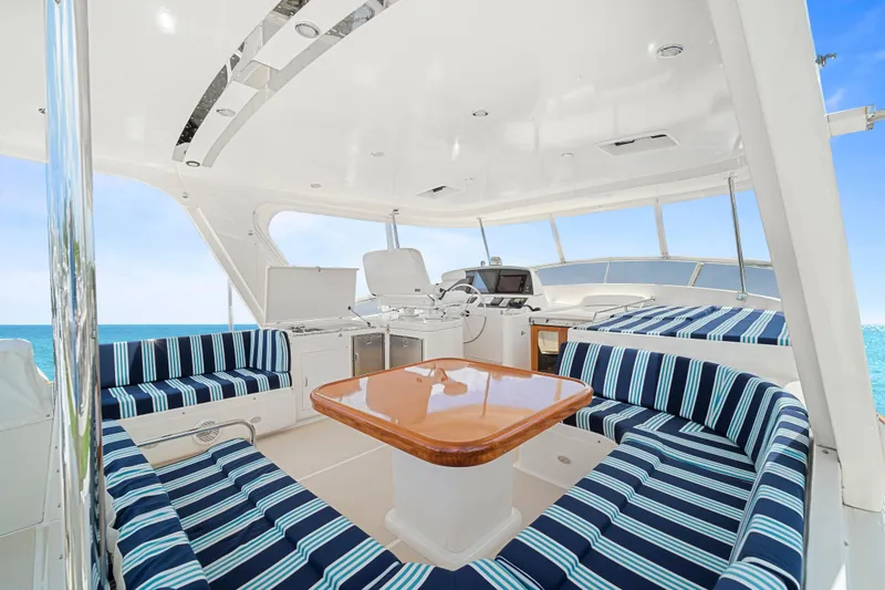 Slide: The Image of Luxurious 2017 Fleming 65 yacht interior with striped seating and ocean view. - 24