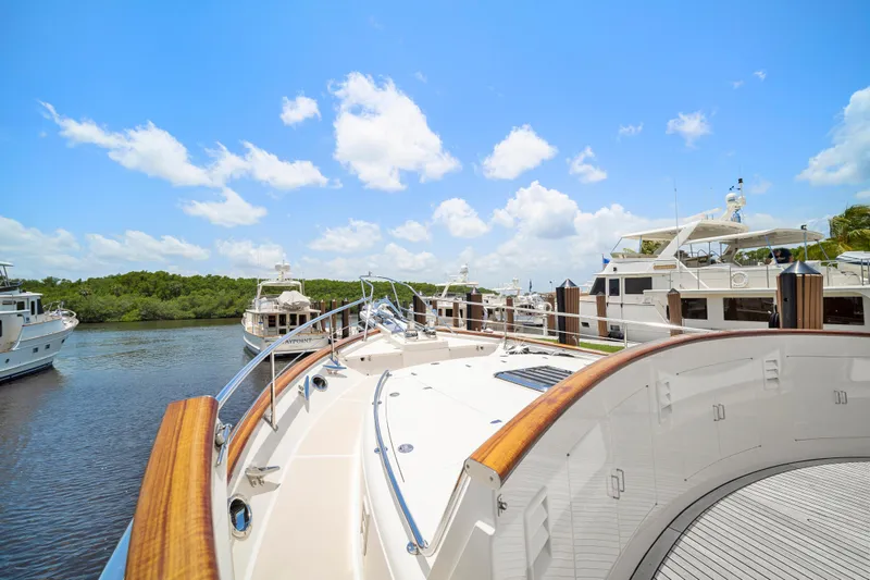 Slide: The Image of Luxury Fleming 65 yacht docked in a serene marina, 2017 model, under a clear blue sky. - 37