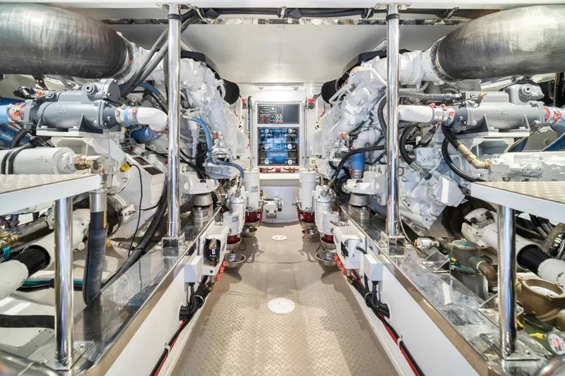 Slide: The Image of Engine room of a 2017 Fleming 65 yacht, showcasing dual engines and control systems. - 41
