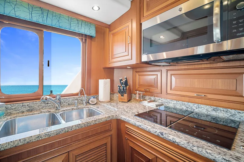 Slide: The Image of Luxurious kitchen in 2017 Fleming 65 yacht with ocean view, granite countertops, and modern appliances. - 8