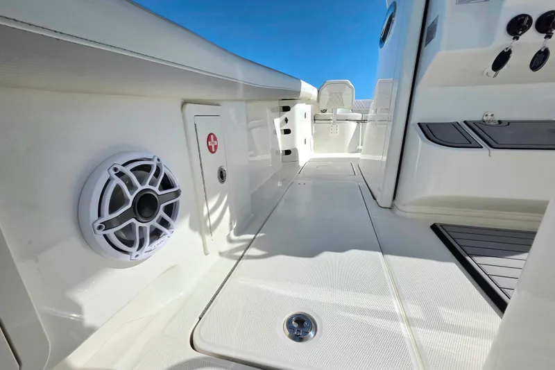 Slide: The Image of 2024 World Cat 325 CC boat interior with speaker and storage compartments. - 14