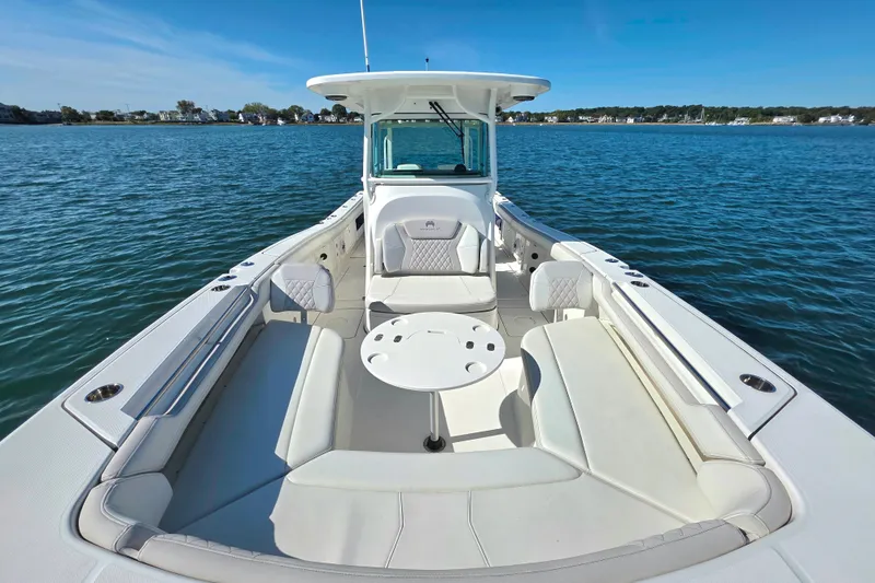 Slide: The Image of 2024 World Cat 325 CC boat with spacious seating on calm water. - 15