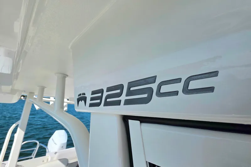 Slide: The Image of 2024 World Cat 325 CC boat logo on white surface, with ocean background. - 17