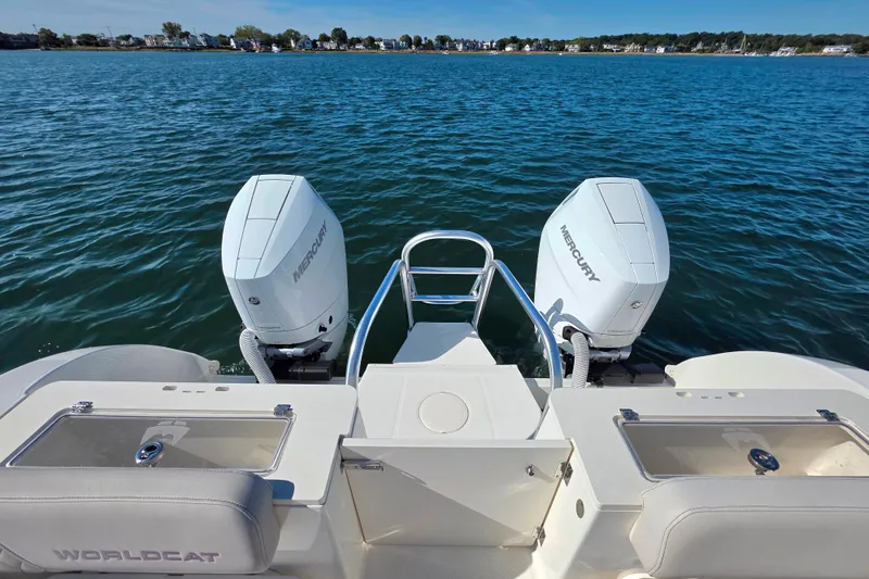 Slide: The Image of 2024 World Cat 325 CC boat with dual Mercury engines on open water. - 6