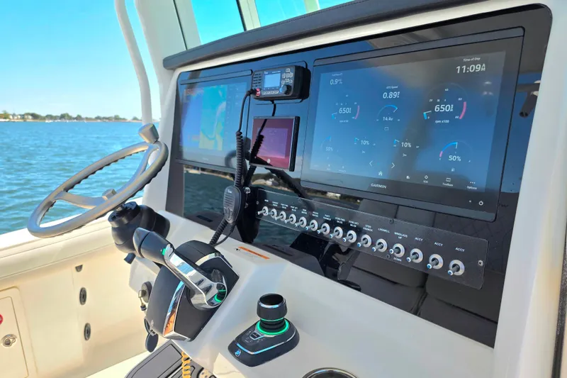 Slide: The Image of 2024 World Cat 325 CC boat dashboard with advanced navigation and control systems. - 7