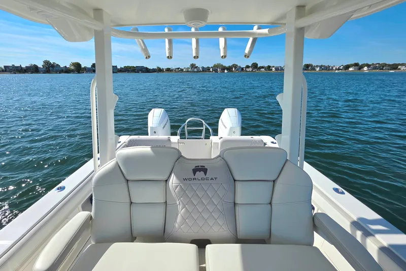 Slide: The Image of 2024 World Cat 325 CC boat interior with luxurious seating on calm water. - 8