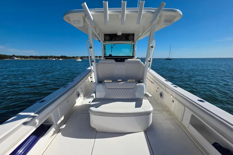 Slide: The Image of 2024 World Cat 325 CC boat on calm blue water, featuring spacious seating and sleek design. - 9