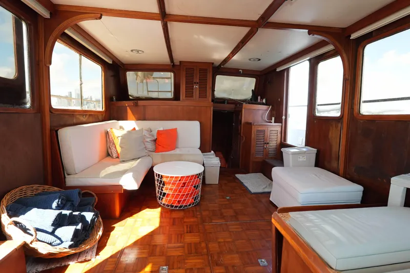 Slide: The Image of Interior of 1982 CHB Classic Trawler 41 with cozy seating and wooden decor. - 11