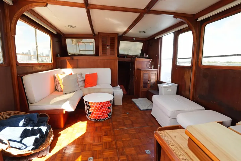 Slide: The Image of Interior of 1982 CHB Classic Trawler 41 with cozy seating and wooden decor. - 13