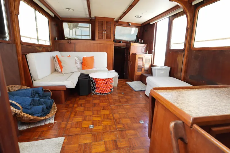 Slide: The Image of Interior of 1982 CHB Classic Trawler 41 with cozy seating and wooden decor. - 14