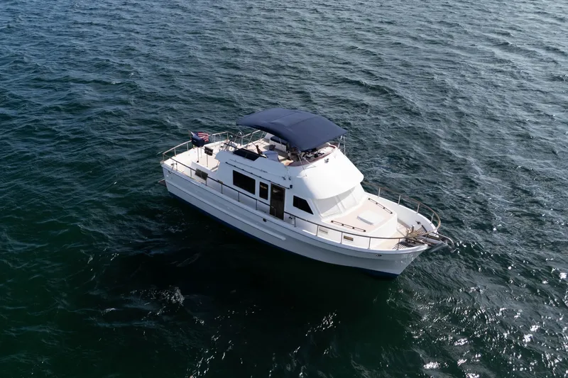 Slide: The Image of 1982 CHB Classic Trawler 41 cruising on open water, aerial view. - 2