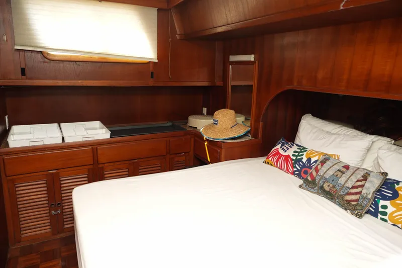 Slide: The Image of 1982 CHB Classic Trawler 41 cabin with wooden interior and colorful pillows. - 20