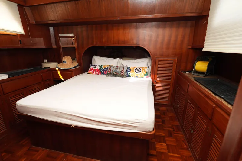 Slide: The Image of Cozy cabin interior of 1982 CHB Classic Trawler 41 with wooden furnishings and bed. - 22