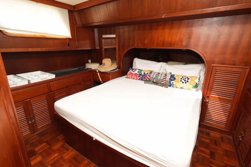 Slide: The Image of Cozy cabin interior of 1982 CHB Classic Trawler 41 with wooden furnishings and colorful pillows. - 23
