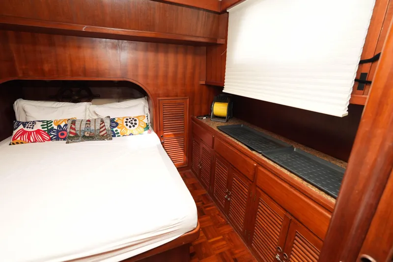 Slide: The Image of Cozy cabin interior of 1982 CHB Classic Trawler 41 with wooden furnishings and colorful pillows. - 24