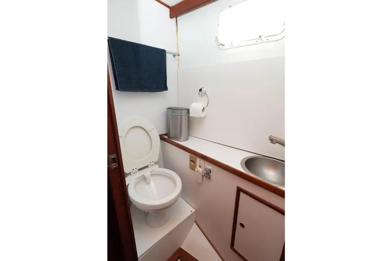 Slide: The Image of 1982 CHB Classic Trawler 41 bathroom with toilet, sink, and towel. - 26