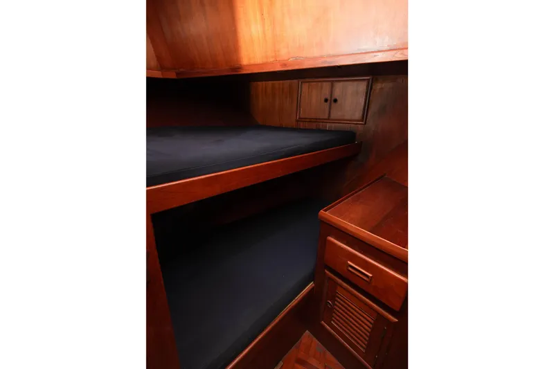 Slide: The Image of 1982 CHB Classic Trawler 41 interior with wooden bunk beds and storage cabinet. - 31