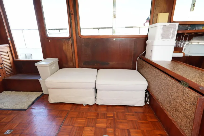 Slide: The Image of Interior of 1982 CHB Classic Trawler 41 with wooden paneling and cushioned seating. - 32