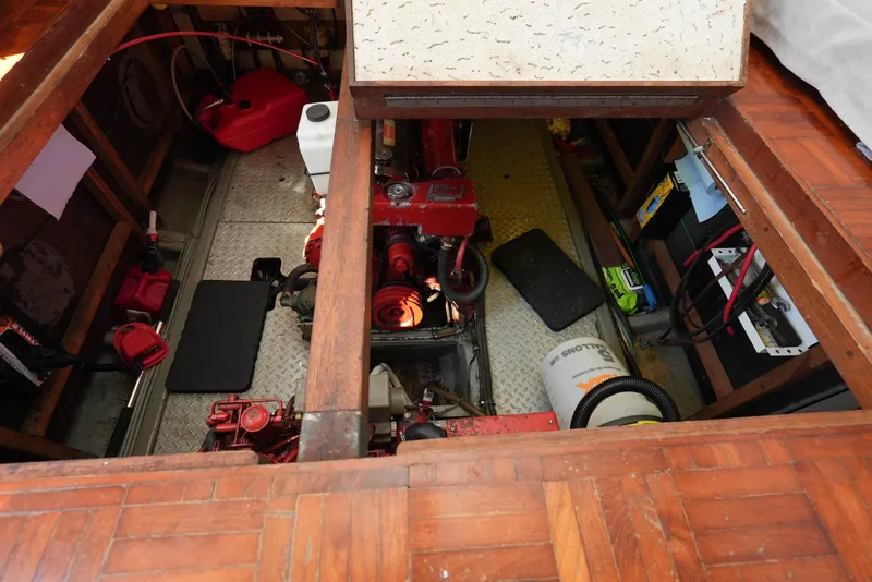 Slide: The Image of Engine room of 1982 CHB Classic Trawler 41, featuring red machinery and storage compartments. - 33