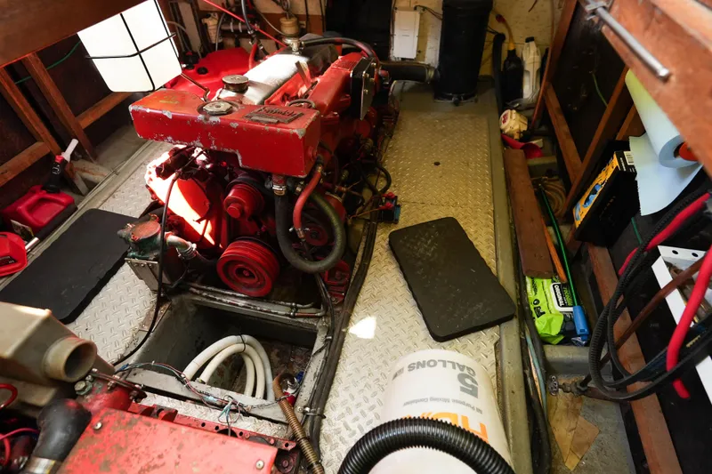 Slide: The Image of Engine room of 1982 CHB Classic Trawler 41 with red engine and various equipment. - 34