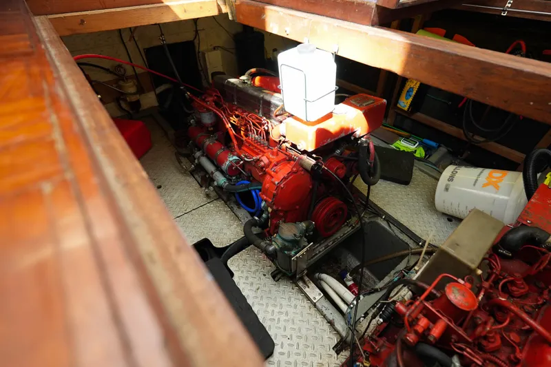 Slide: The Image of Engine room of 1982 CHB Classic Trawler 41 with visible red engine components. - 35