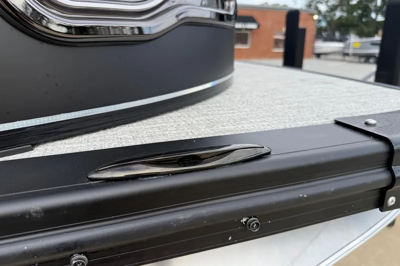 Slide: The Image of 2026 Avalon LSZ Rear Fish boat detail, featuring sleek black trim and textured surface. - 11