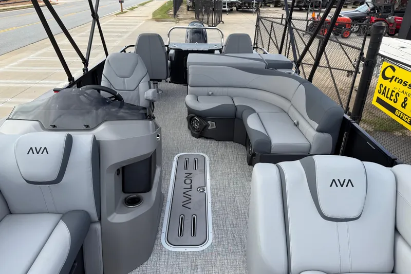 Slide: The Image of 2026 Avalon LSZ Rear Fish pontoon boat interior with gray seating and steering console. - 15