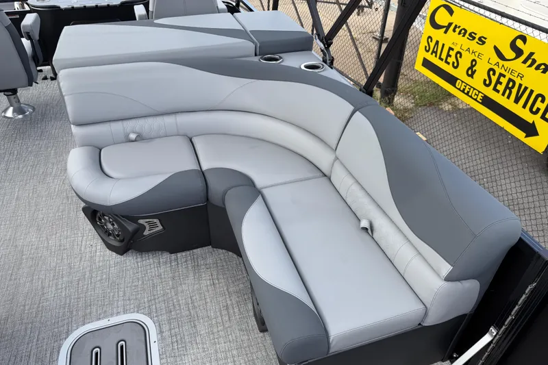 Slide: The Image of 2026 Avalon LSZ Rear Fish boat with gray seating and cup holders, displayed at sales office. - 17