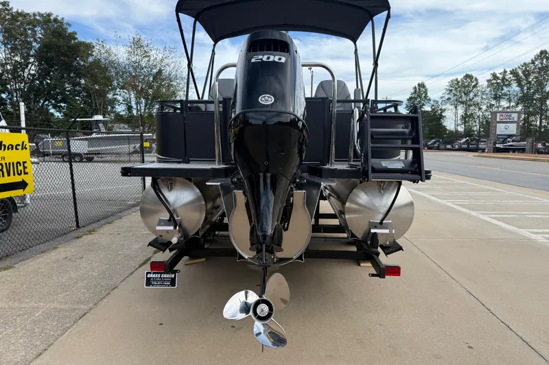 Slide: The Image of 2026 Avalon LSZ Rear Fish boat with powerful outboard motor, parked on a trailer. - 3