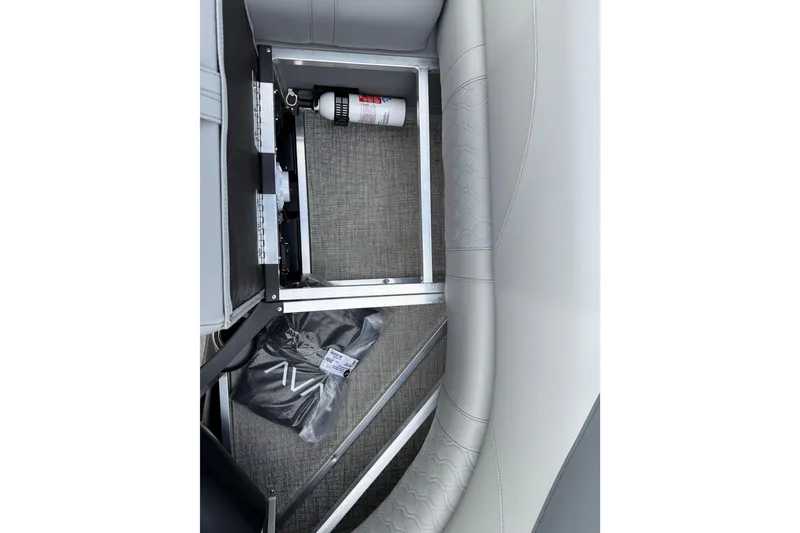 Slide: The Image of 2026 Avalon LSZ Rear Fish boat storage compartment with fire extinguisher and accessories. - 37
