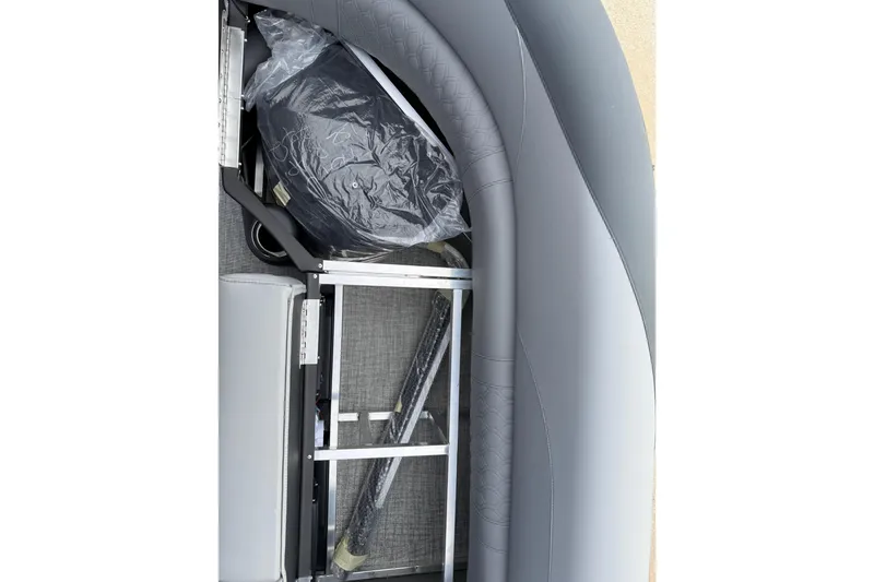 Slide: The Image of 2026 Avalon LSZ Rear Fish boat interior with gray seating and storage area. - 38