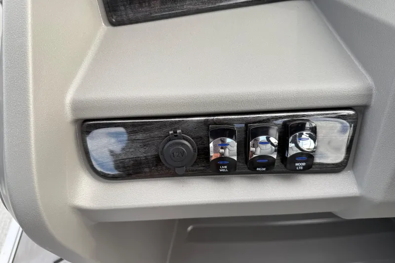 Slide: The Image of Control panel of 2026 Avalon LSZ Rear Fish with switches for live well, bilge, and mood lights. - 42