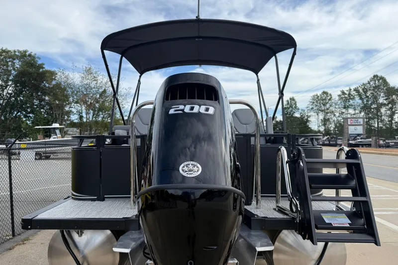 Slide: The Image of 2026 Avalon LSZ Rear Fish pontoon boat with 200 HP engine, docked outdoors. - 5