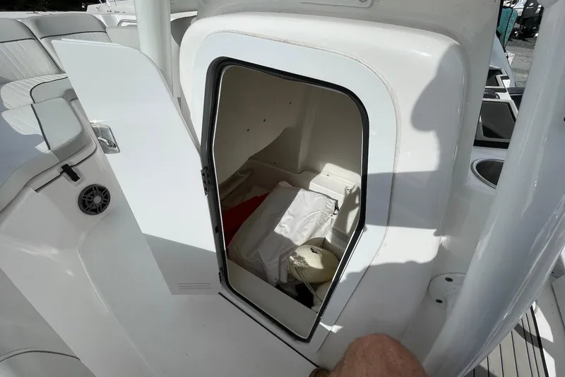 Slide: The Image of 2022 Sea Fox 228 Commander boat storage compartment with open door. - 33