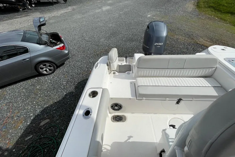 Slide: The Image of 2022 Sea Fox 228 Commander boat with Yamaha 200 engine, parked beside a car. - 36