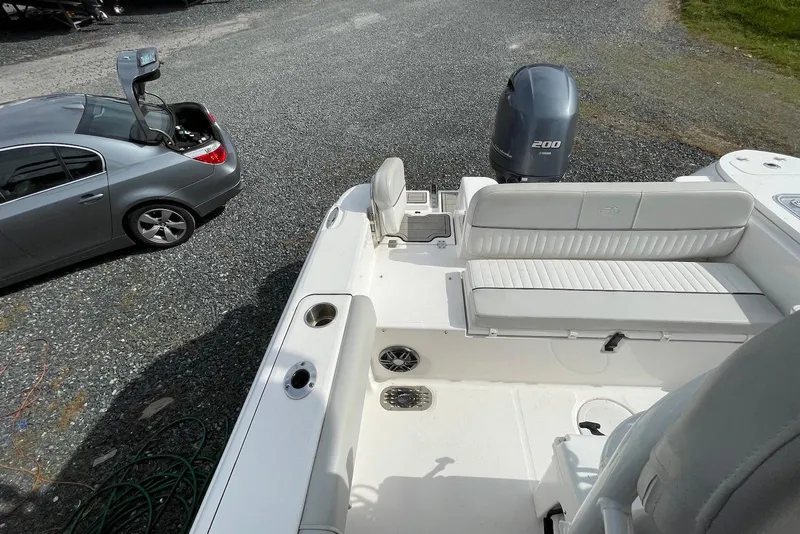 Slide: The Image of 2022 Sea Fox 228 Commander boat with Yamaha 200 engine, parked beside a car. - 37