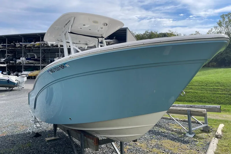 Slide: The Image of 2022 Sea Fox 228 Commander boat in storage, light blue hull, outdoor setting. - 4
