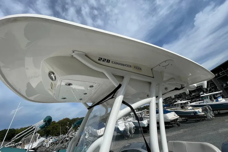 Slide: The Image of 2022 Sea Fox 228 Commander boat with T-top, docked under a cloudy sky. - 48