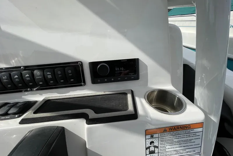 Slide: The Image of 2022 Sea Fox 228 Commander dashboard with controls, radio, and cup holder. - 50