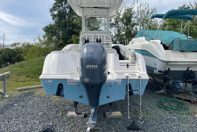Slide: The Image of 2022 Sea Fox 228 Commander boat with Yamaha 200 engine, parked on gravel. - 59