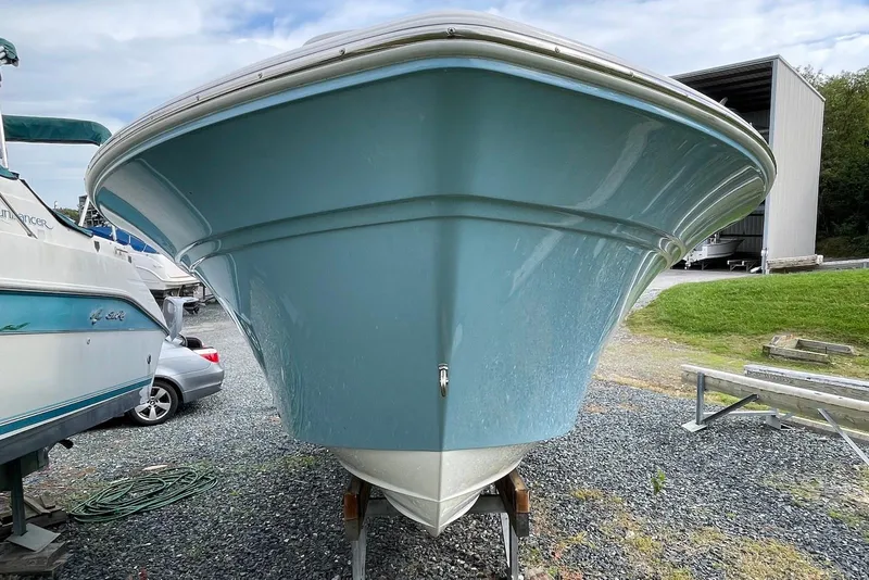 Slide: The Image of 2022 Sea Fox 228 Commander boat, light blue hull, parked on gravel. - 6